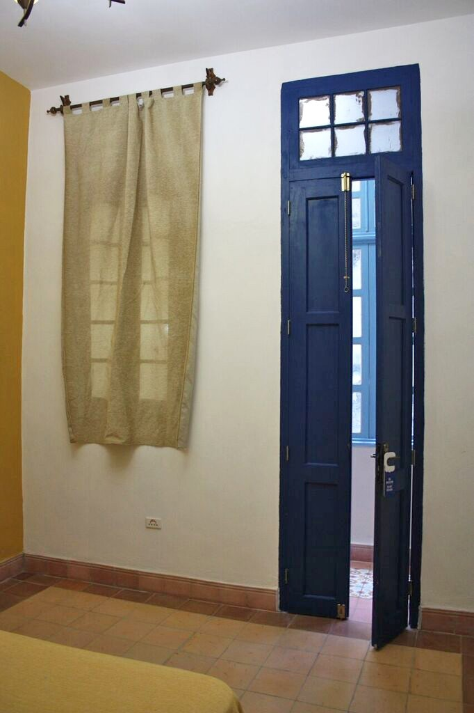 The yellow room in La Gargola Guesthouse in Old Havana, Cuba